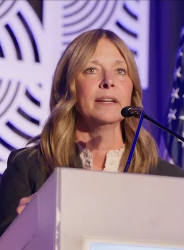 Amy Acton speaking at a podium in 2025