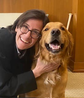 Official court portrait of U.S. District Judge Ana C. Reyes with her dog Scout