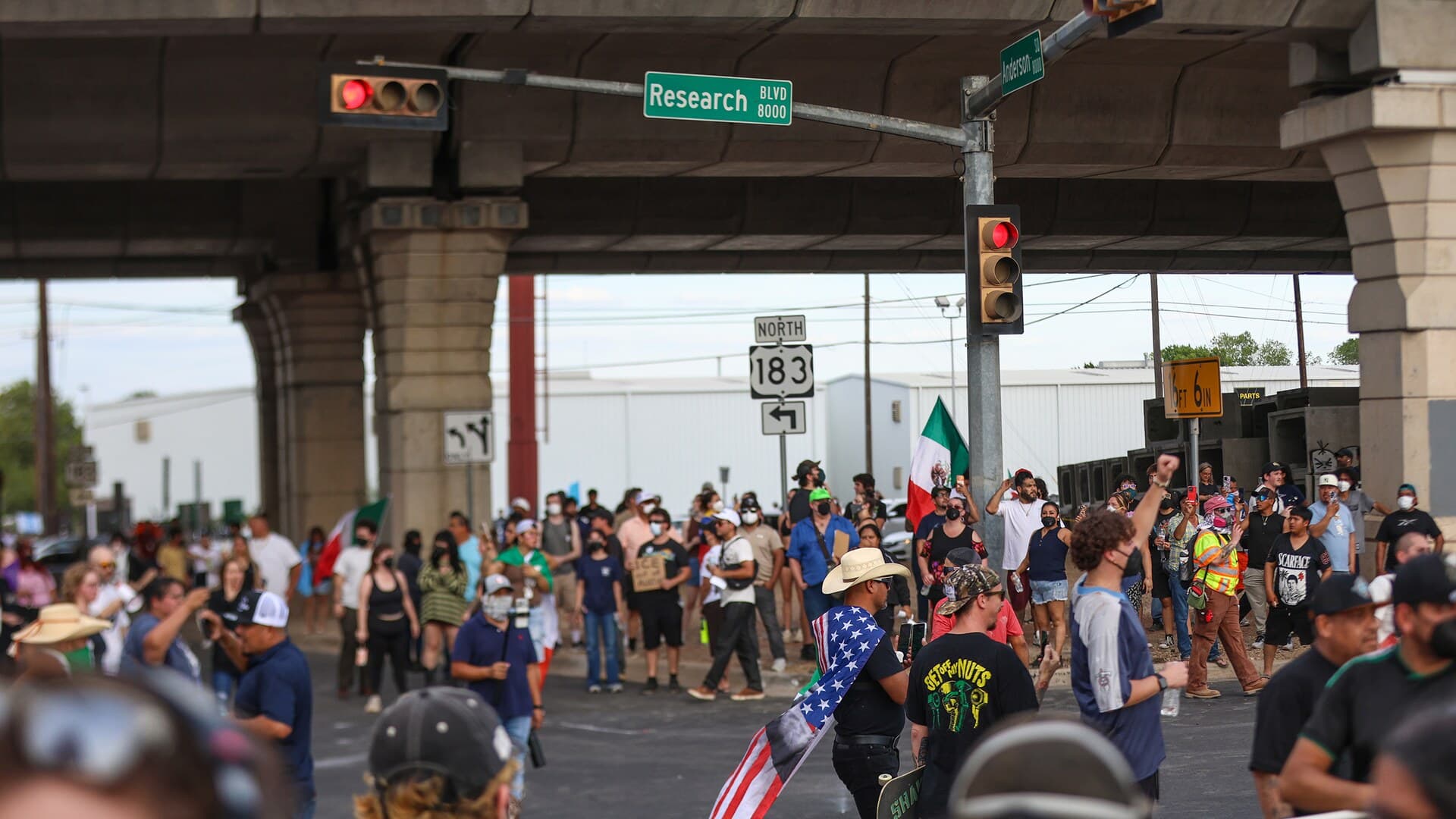 Protesters fill the intersection of West Anderson and Research Boulevard in Austin after an ICE officer shot Wilber Rafael Garces Perez.