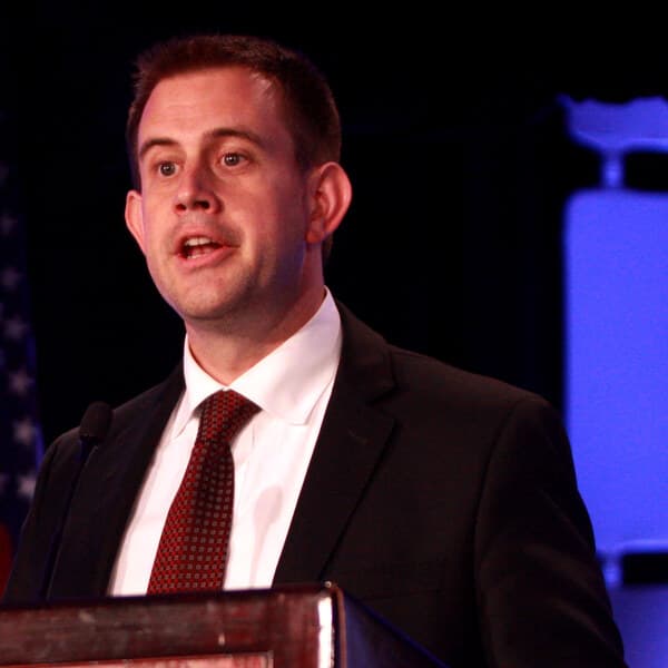 Jesse Binnall speaking at a lectern.