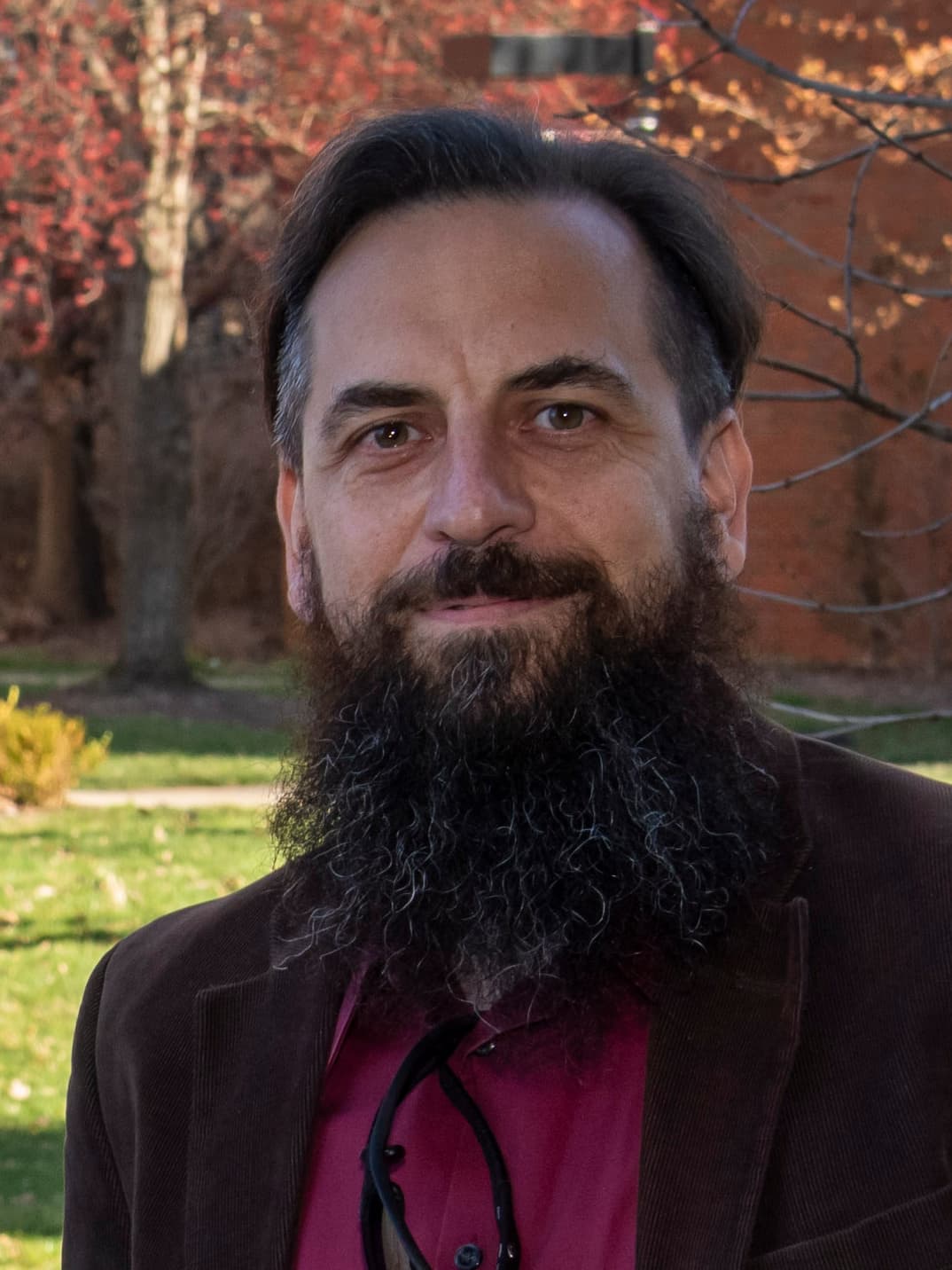 Roman Yampolskiy portrait, outdoors in front of a brick building.