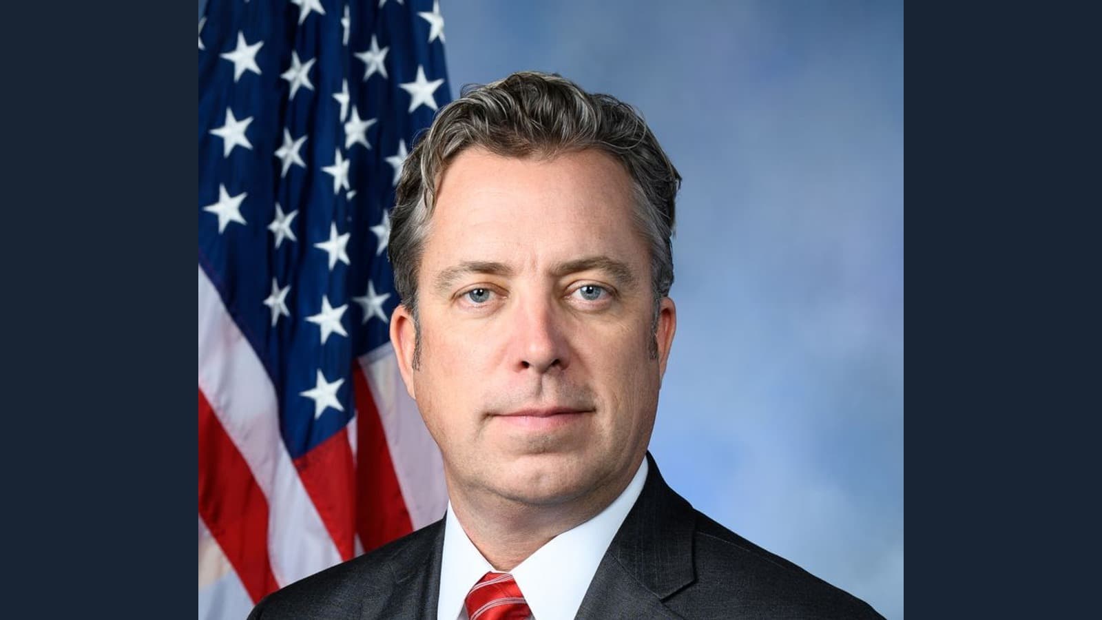 Andy Ogles in an official congressional portrait with a U.S. flag behind him.