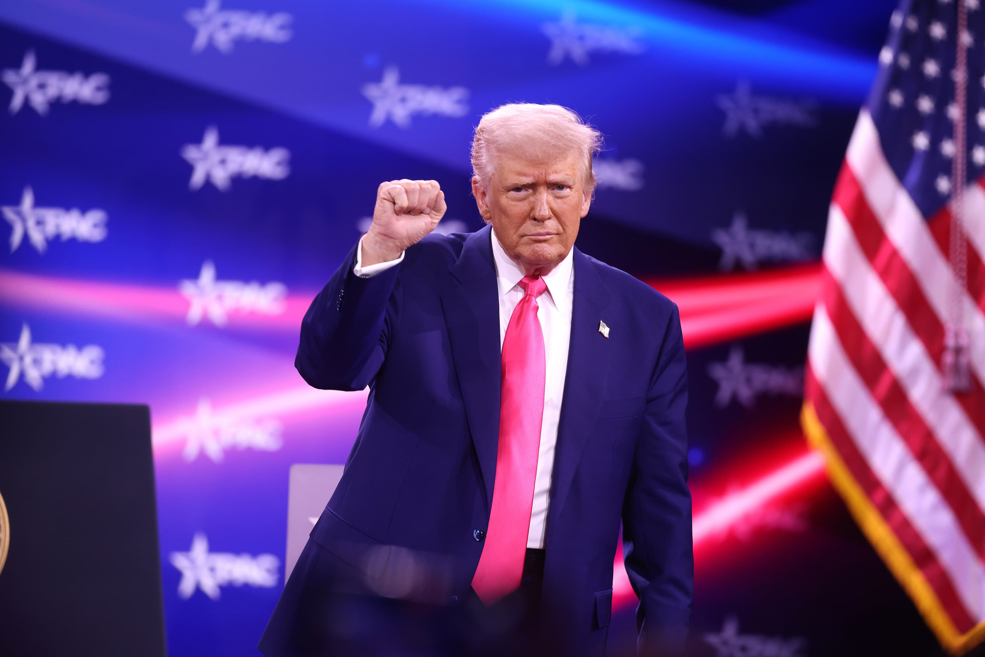 Donald Trump raising his fist at CPAC in National Harbor, Maryland, on February 22, 2025.
