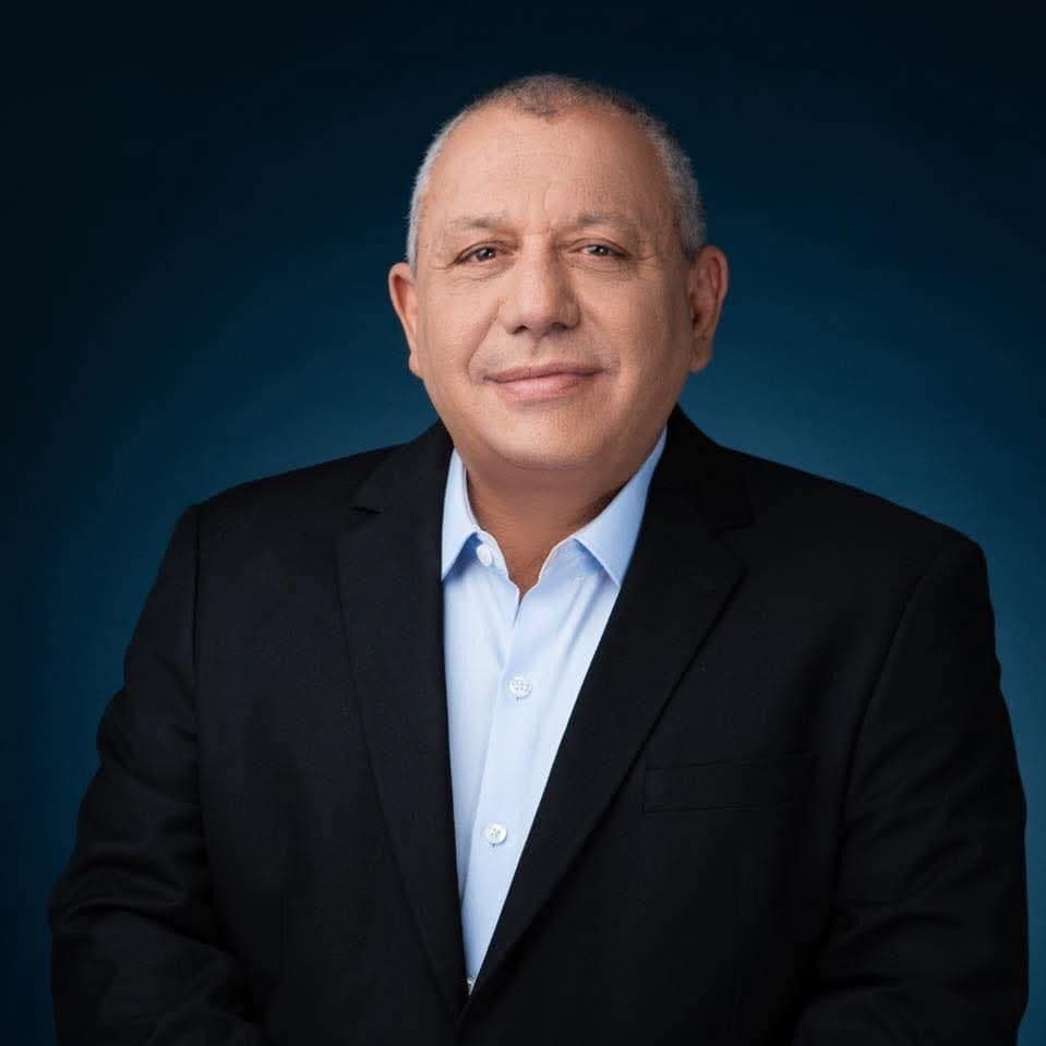 Gadi Eisenkot in a dark jacket and light blue open-collared shirt against a dark blue background.