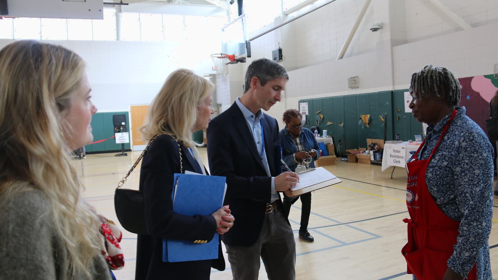 Election observers speak with a poll worker at a Washington, D.C., polling station.