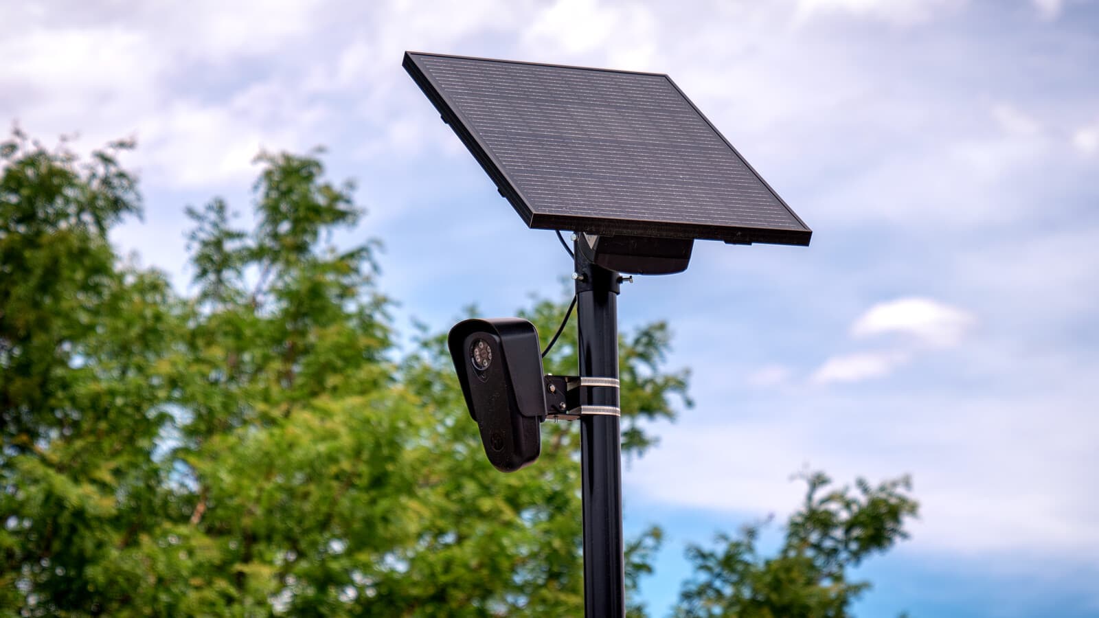 A Flock Safety automated license-plate reader mounted below a solar panel.
