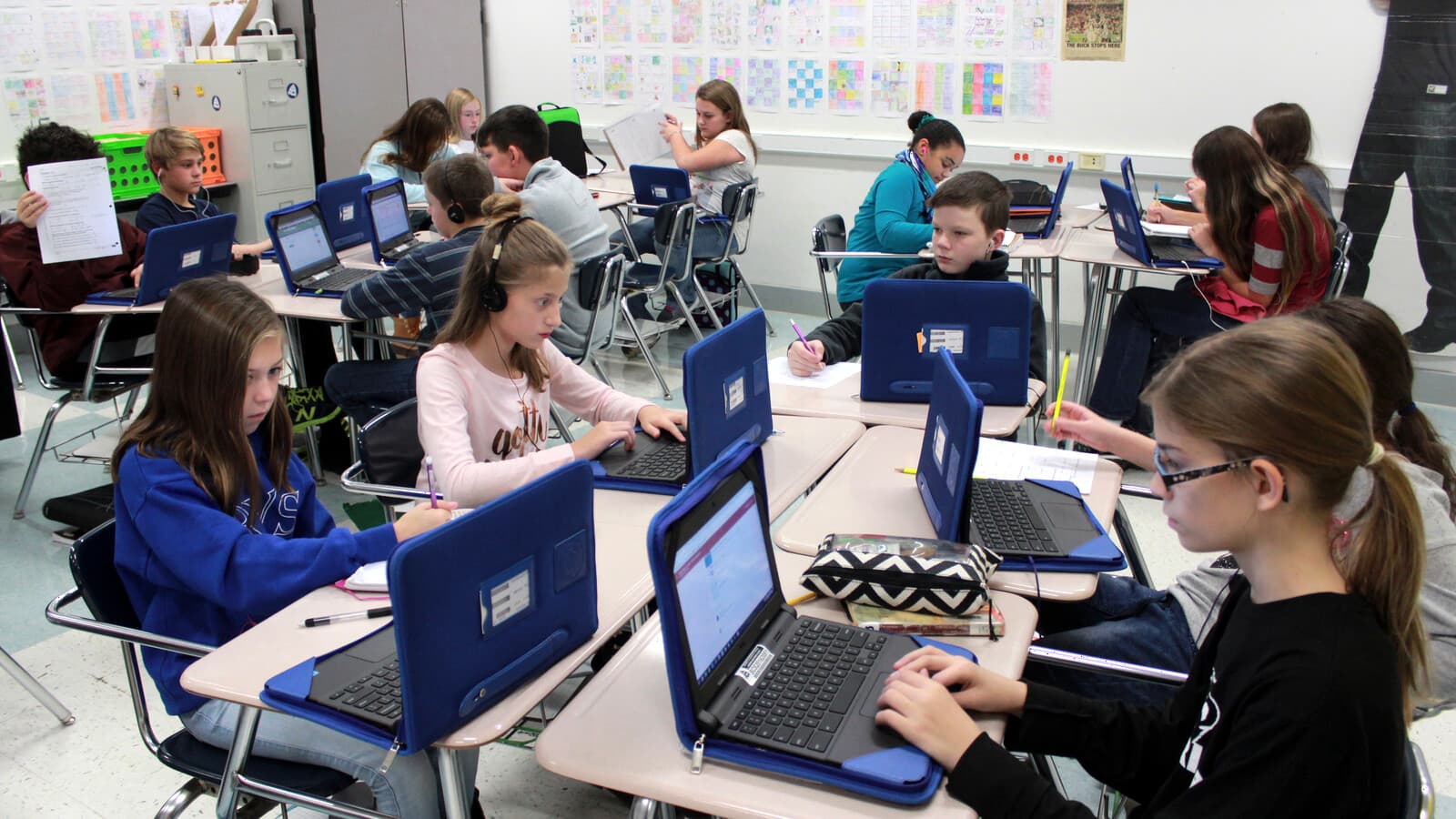 Middle-school students work on Chromebooks in a classroom.