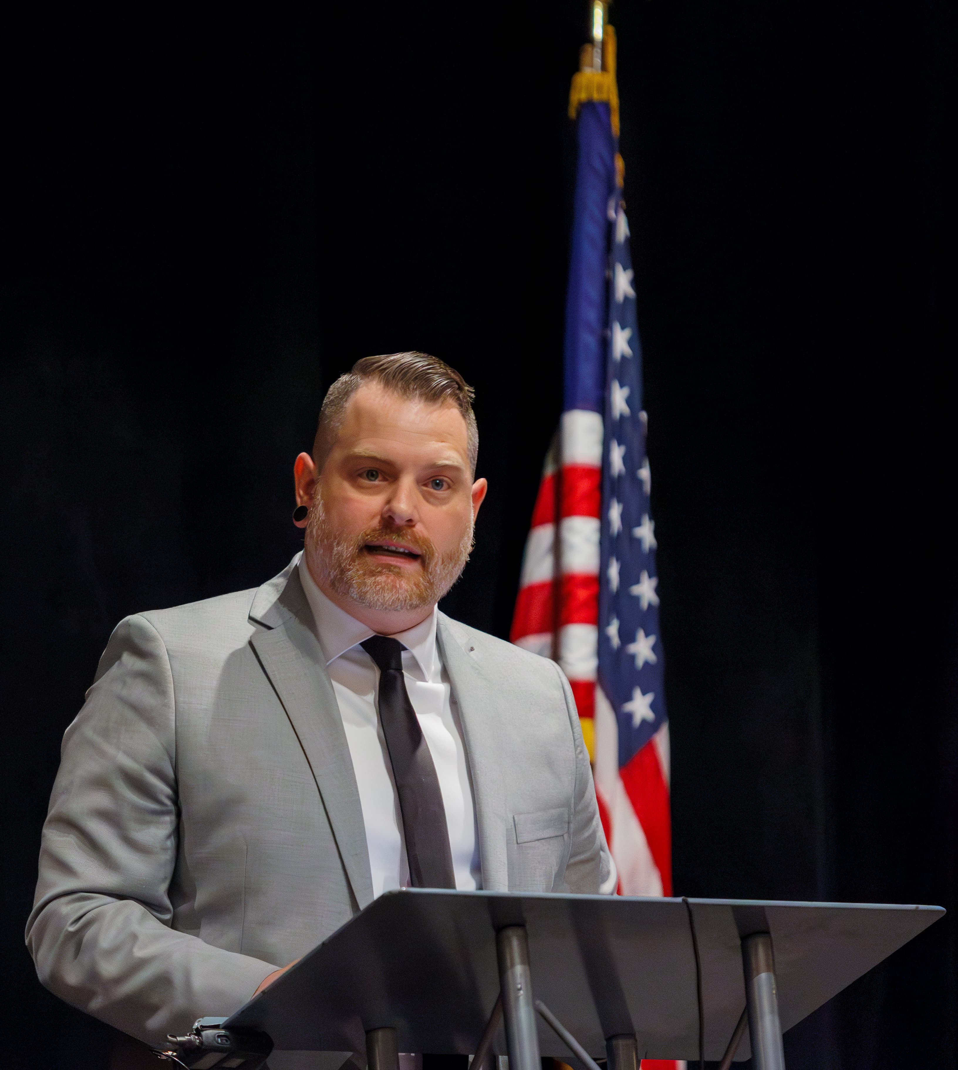Justin Douglas, Dauphin County commissioner, speaking at a podium