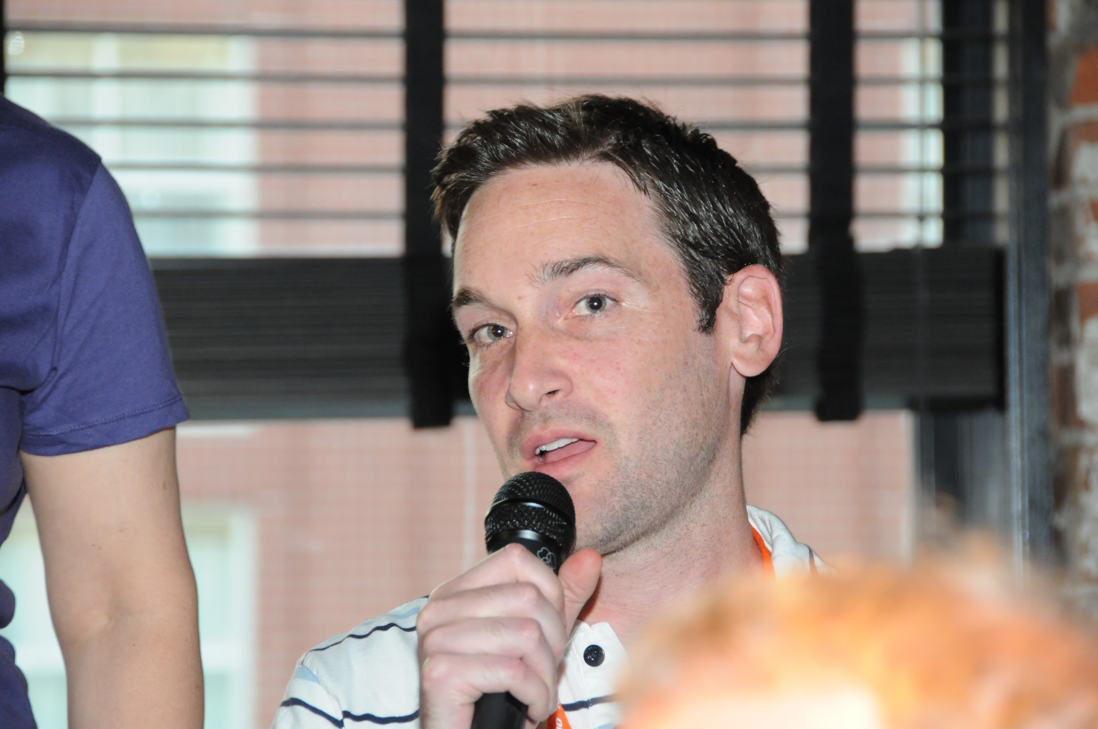 Judd Legum speaking into a microphone in 2009