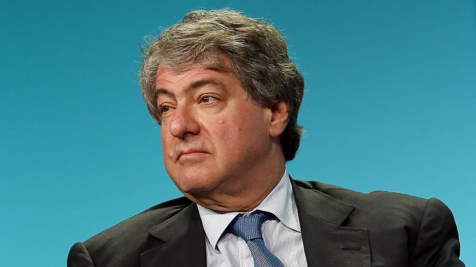 Leon Black sits against a blue background in a file photograph.