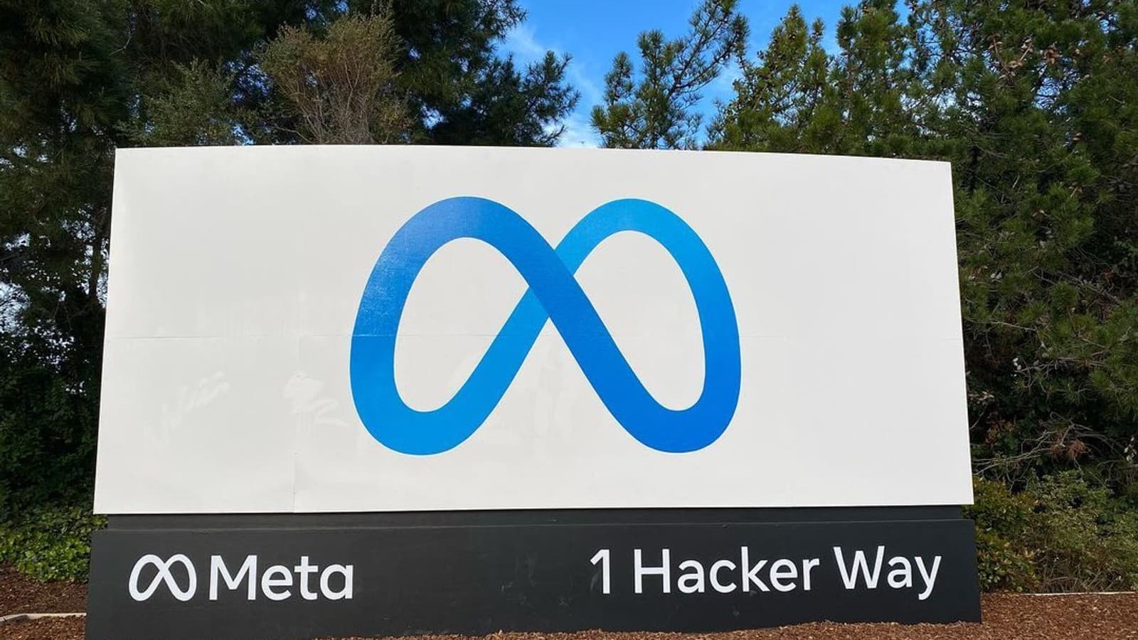 The Meta logo and company name on the entrance sign at its Menlo Park headquarters.