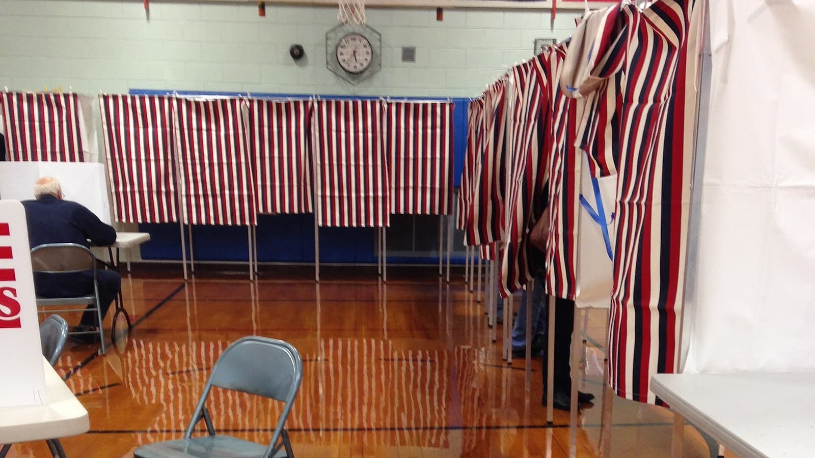 Red, white and blue curtains on voting booths at a Nashua polling station.