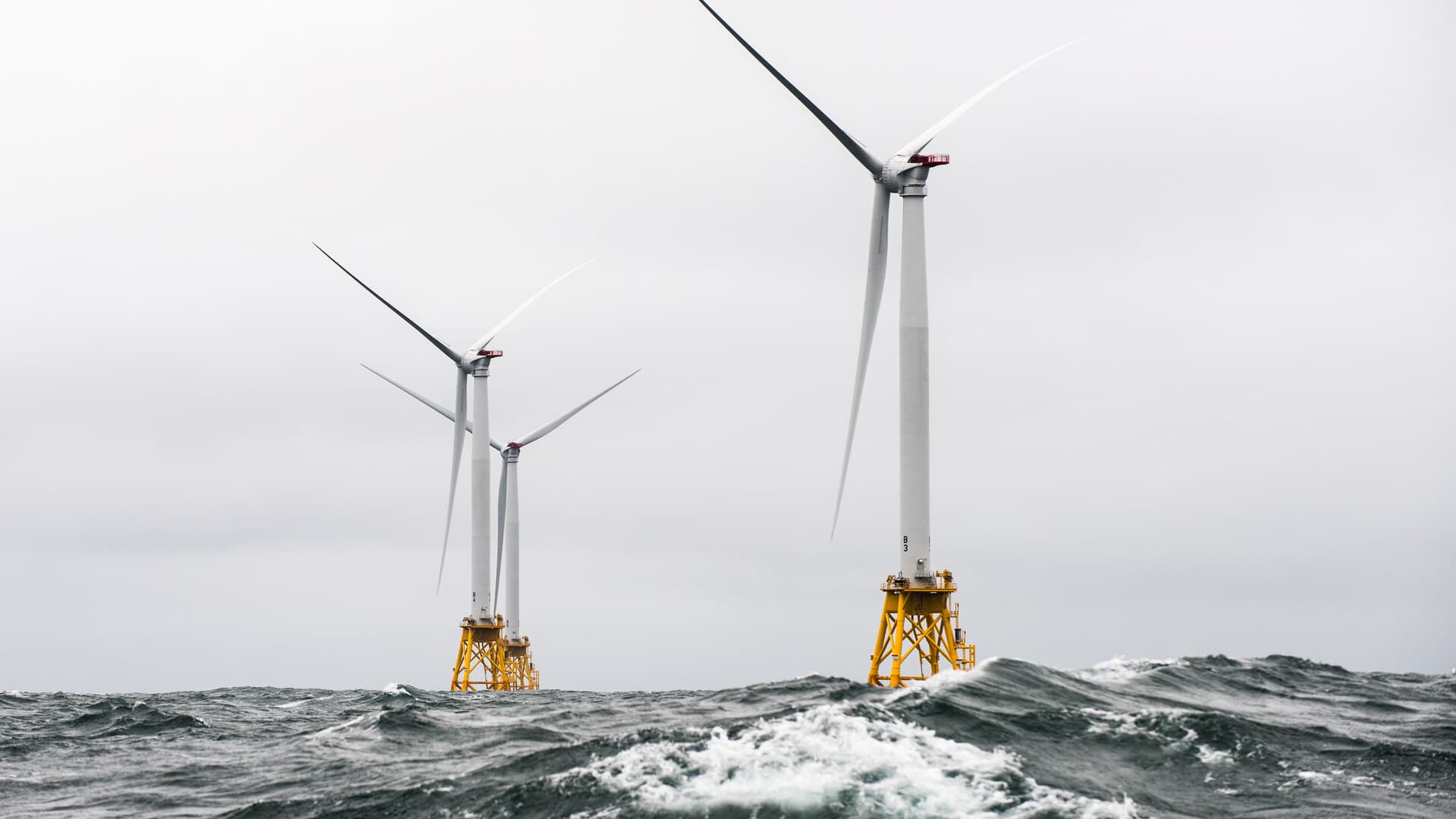 Offshore wind turbines rise above heavy seas at the Block Island Wind Farm.