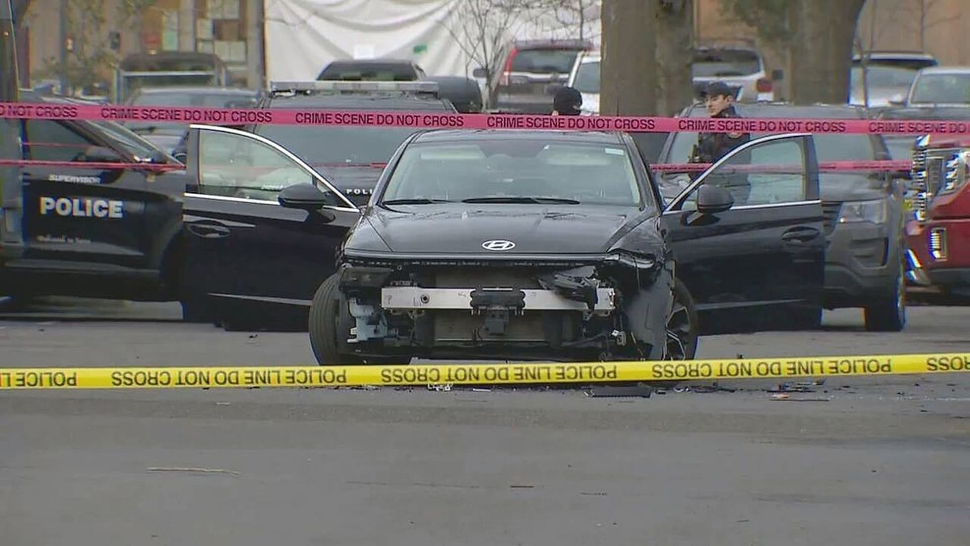 A damaged federal rental car behind crime scene tape in the Portland clinic parking lot where a Border Patrol agent shot two people.