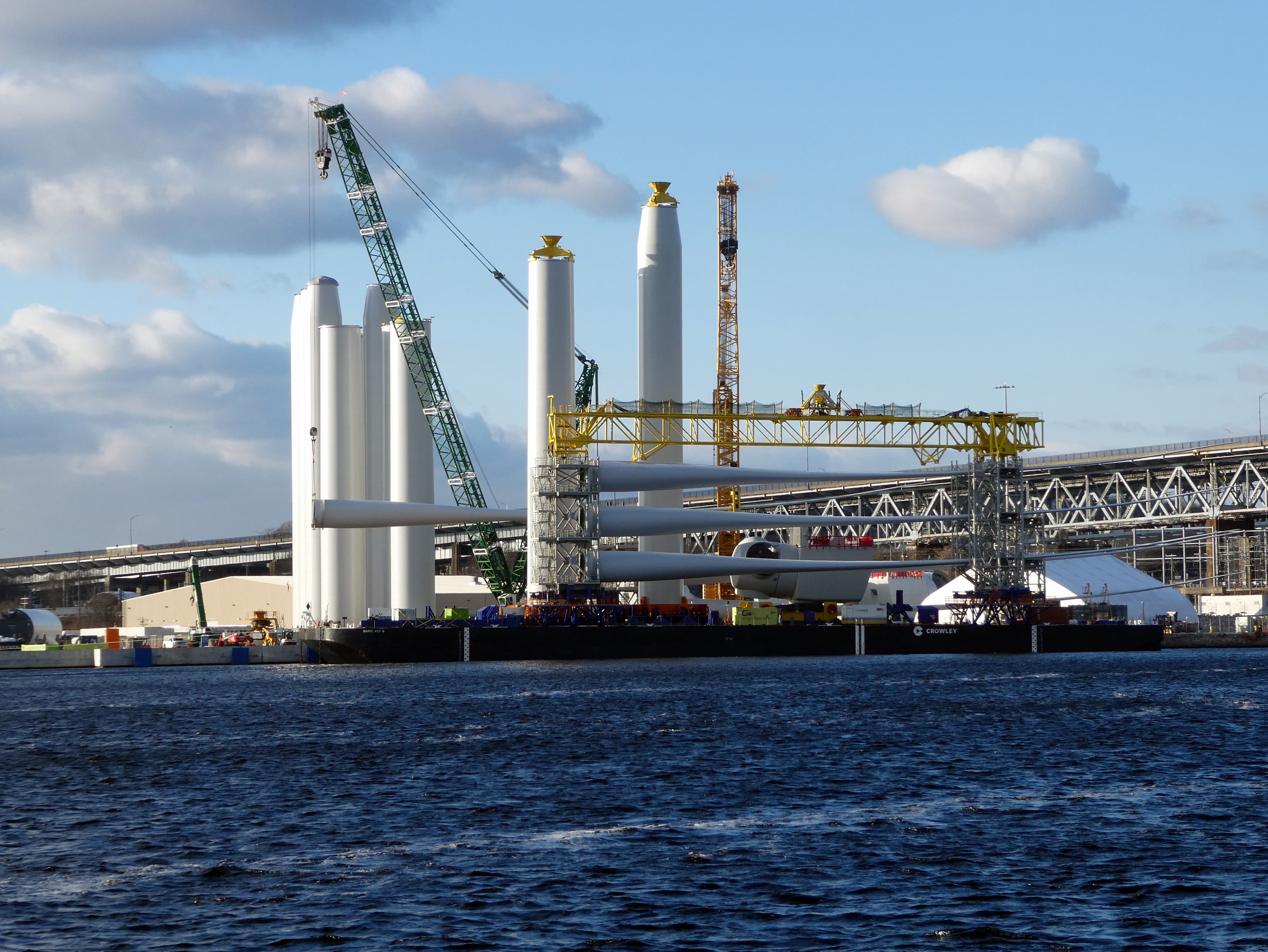 Wind turbine blades and tower components at the New London offshore-wind port.
