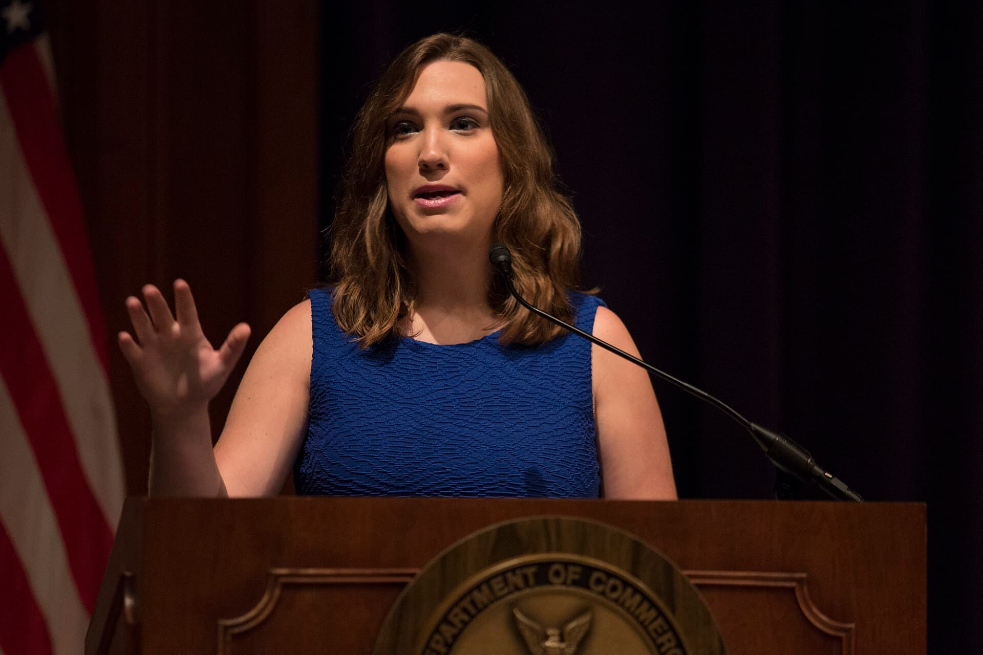 Sarah McBride speaking at a lectern at a 2017 federal Pride Month event.