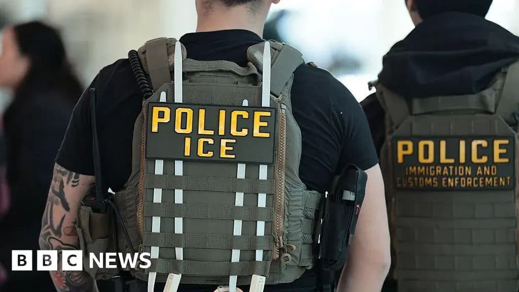 Federal immigration officers, including an ICE agent and a CBP officer, seen from behind at an airport