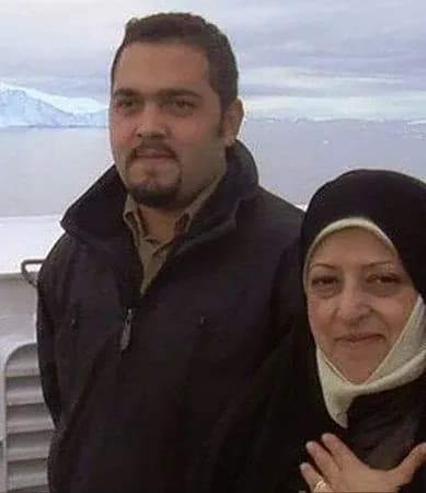 Eissa Hashemi standing beside an unidentified woman in front of an icy landscape