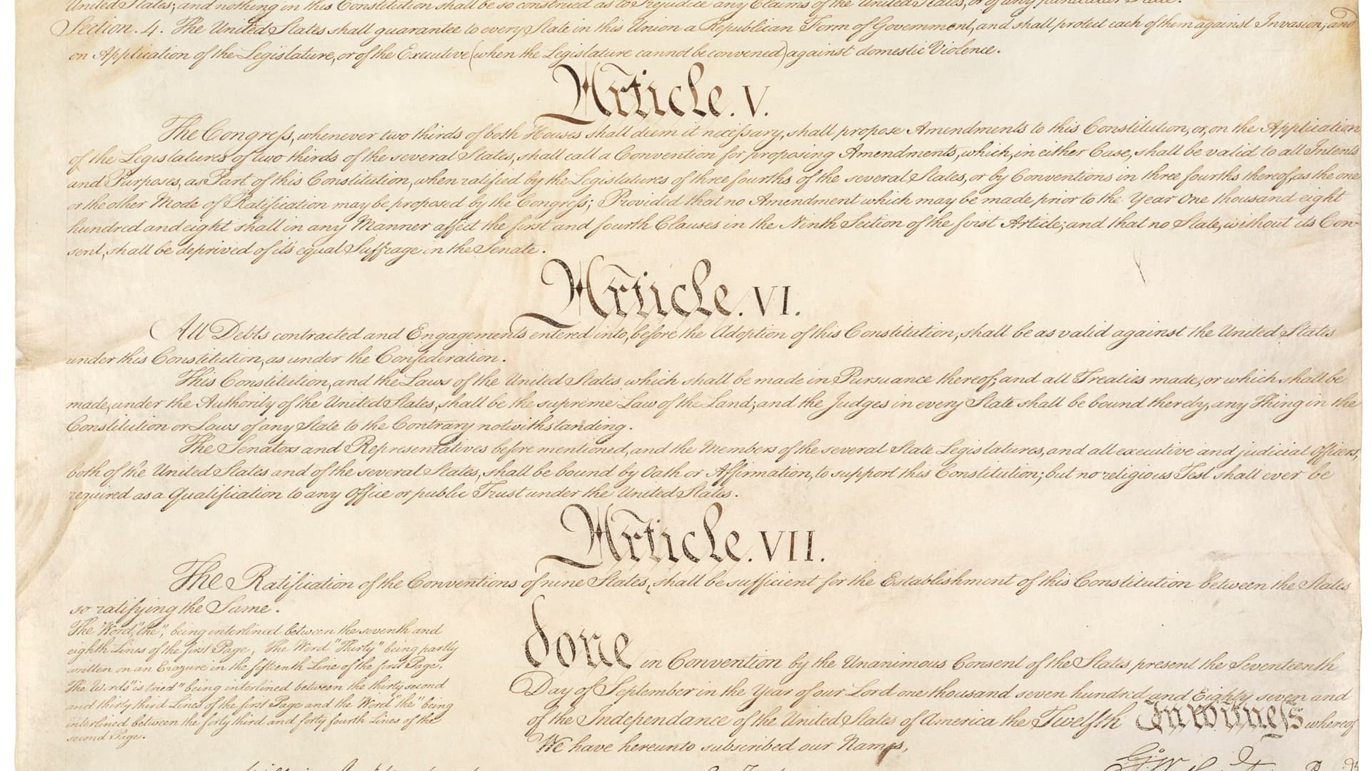 Handwritten page of the engrossed U.S. Constitution showing the headings Article V, Article VI and Article VII in large script, with the Article VI text on debts, the supremacy of federal law and oaths of office.