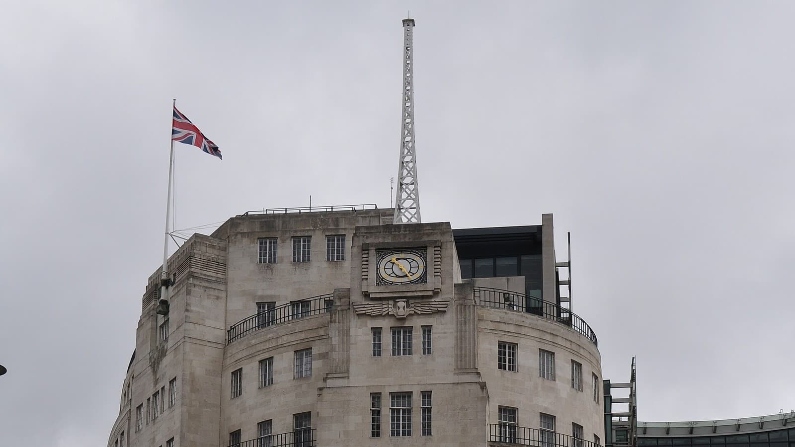 BBC Broadcasting House in London, with its clock, rooftop antenna and Union flag.
