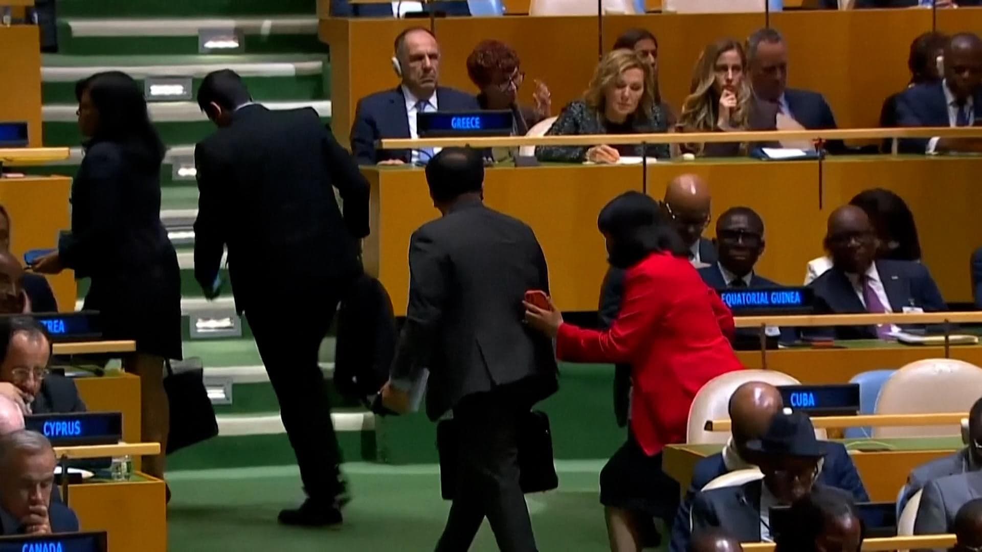 Members of Cuba's delegation leave the United Nations General Assembly during Donald Trump's speech.