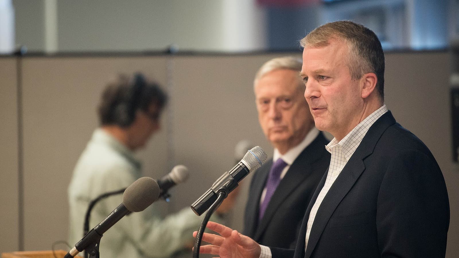 Sen. Dan Sullivan speaks into a microphone at a press conference in Fairbanks, Alaska.