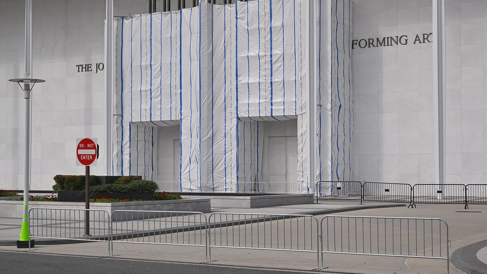 Temporary barriers block the Kennedy Center's entrance and drop-off area.