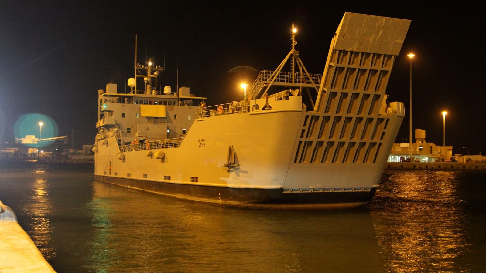 A U.S. Army logistics vessel arrives at Port Shuaiba, Kuwait, at night.