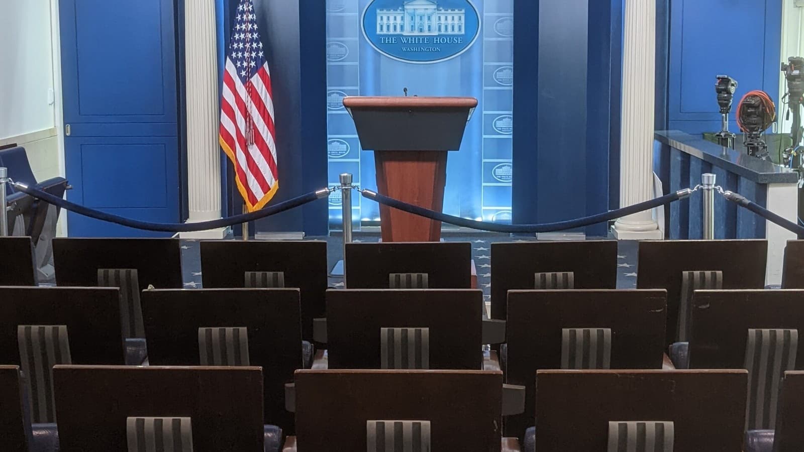 Empty chairs, a podium and television cameras in the White House press briefing room.
